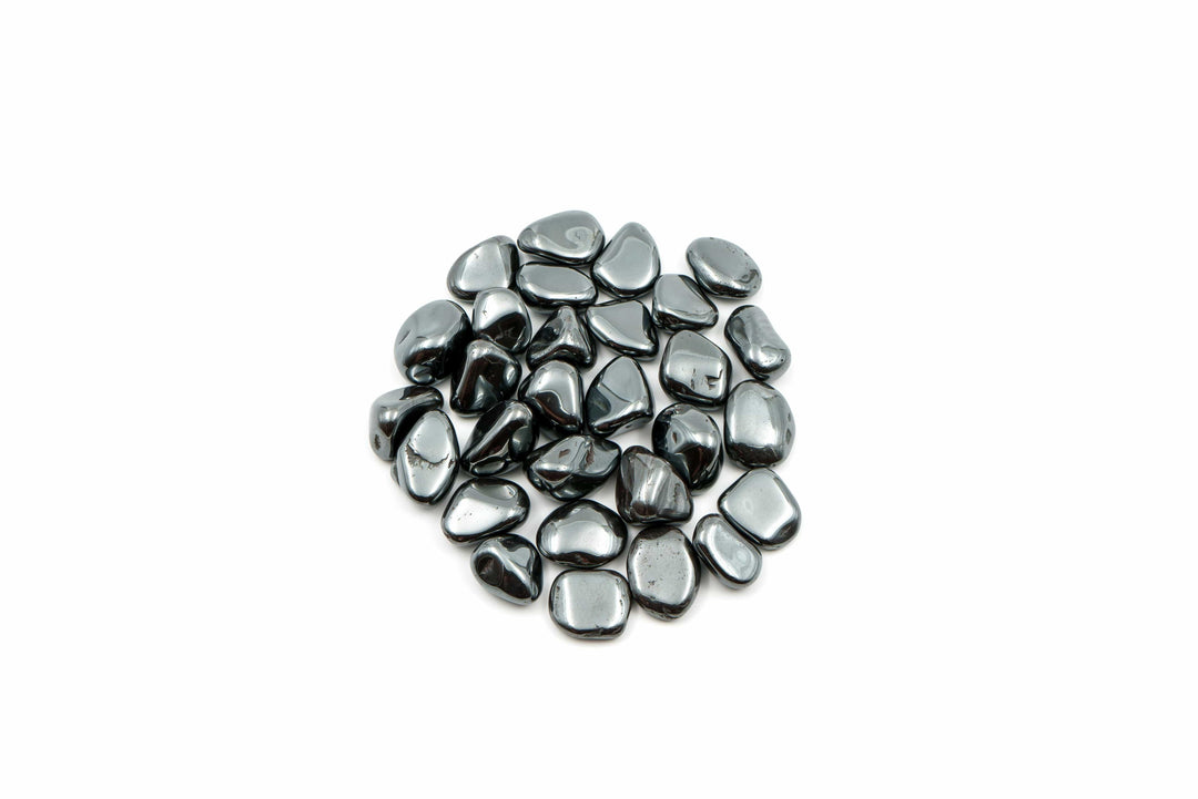 Hematite tumbled stones, associated in tradition with grounding for travel and safe journeys — The Harmony Store