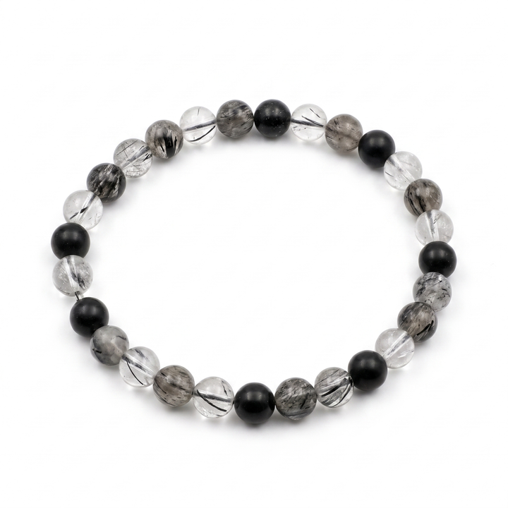 Black Tourmalinated Quartz Bracelet - clear quartz beads with black tourmaline needle inclusions on white background